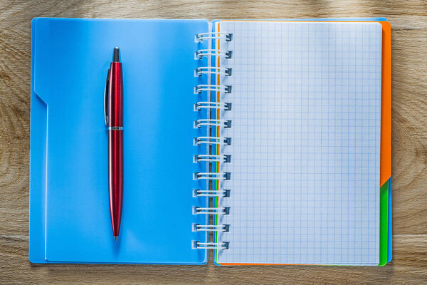 Checked copybook pen on wooden board