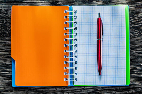 Pen spiral checked notebook on vintage wooden board