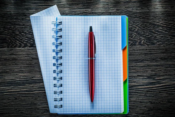 Pen spiral checked notepad on vintage wooden board — Stock Photo, Image