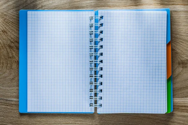 Checked copybook on wooden board — Stock Photo, Image