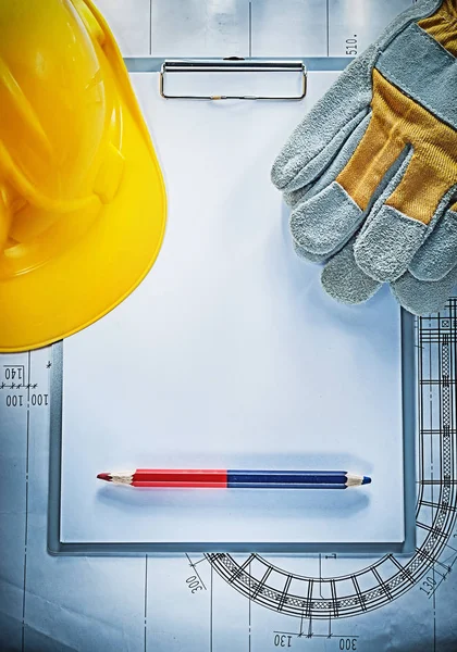 Clipboard pencil building helmet safety gloves on blueprint cons — Stock Photo, Image