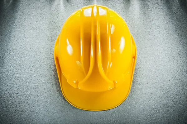 Yellow safety cap on concrete background top view — Stock Photo, Image
