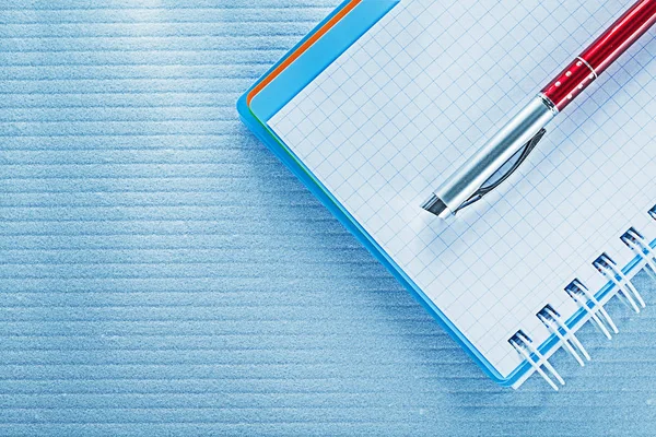 Spiral checked notebook biro pen — Stock Photo, Image