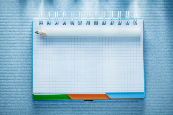 Checked notepad pencil top view