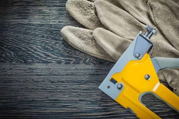 Construction stapler pair of protective gloves — Stock Photo, Image