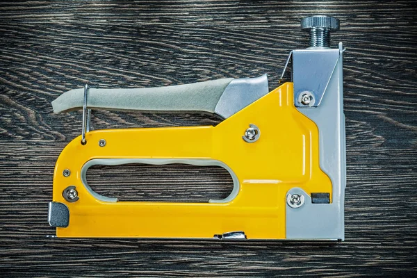 Building stapler gun on wooden board — Stock Photo, Image