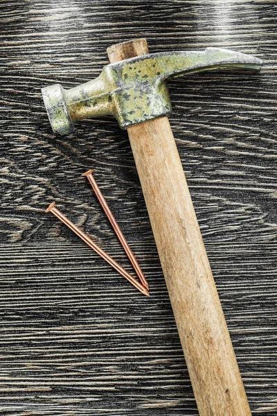Chiodi in ottone artiglio martello su tavola di legno — Foto Stock