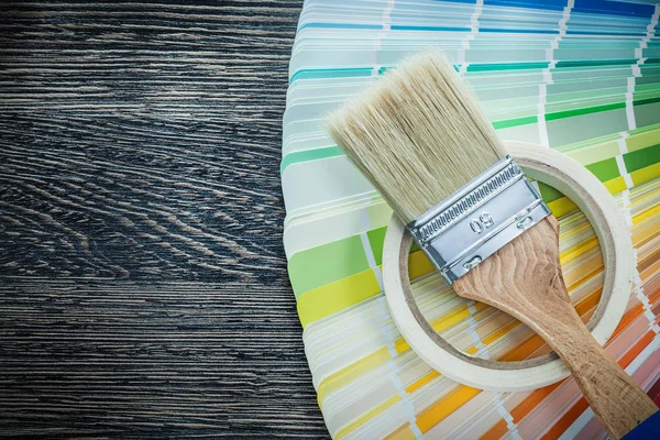 Paintbrush color pantone fan adhesive tape on wooden board — Stock Photo, Image