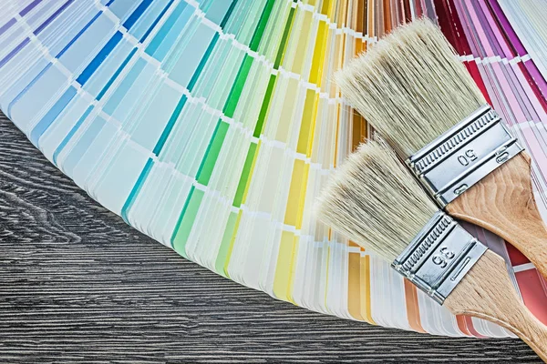 Color sampler paint brushes on wood board — Stock Photo, Image