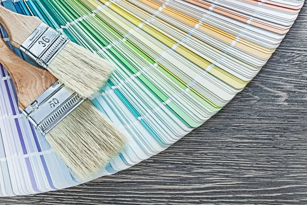 Composition of color palette paintbrushes on wooden board — Stock Photo, Image