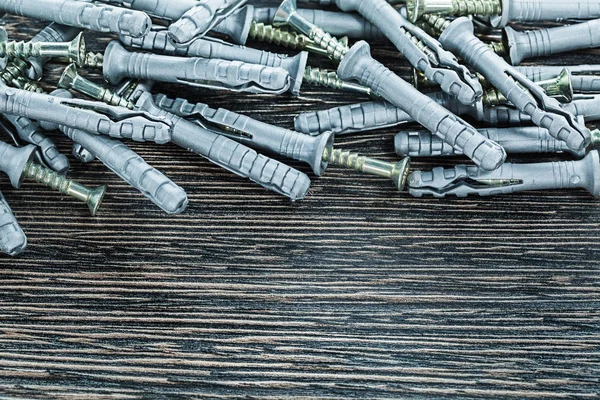 Dowel nails on wooden board — Stock Photo, Image