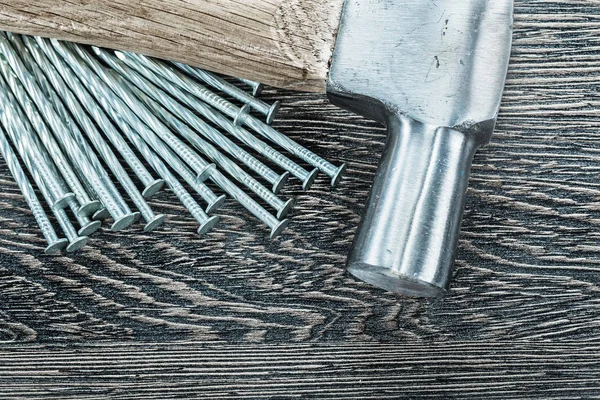 Pile of construction nails claw hammer on wooden board — Stock Photo, Image