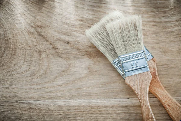 Set of paint brushes on wood board directly above — Stock Photo, Image