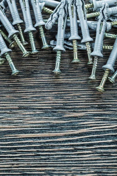 Plastic dowel nails on wooden board — Stock Photo, Image