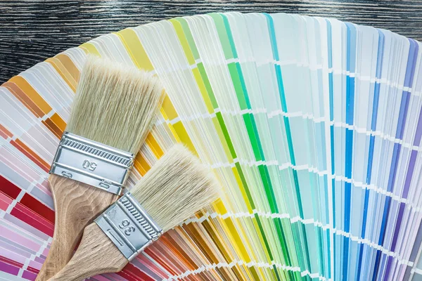 Color sampler paintbrushes on wooden board — Stock Photo, Image