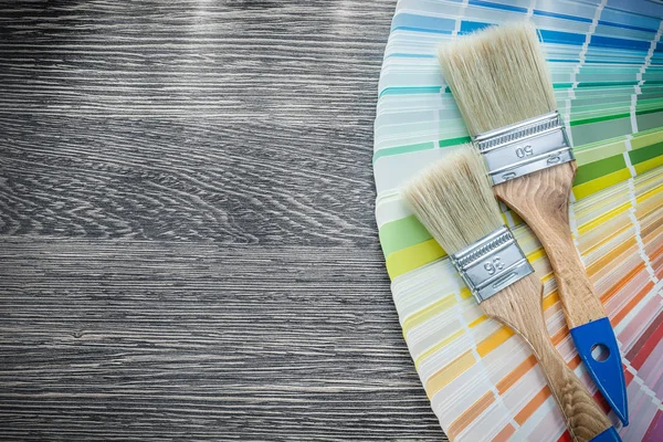 Paint brushes color palette on wood board — Stock Photo, Image