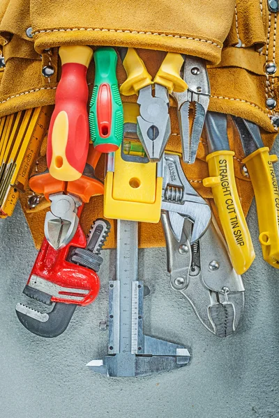 Tool belt construction tooling on concrete background — Stock Photo, Image