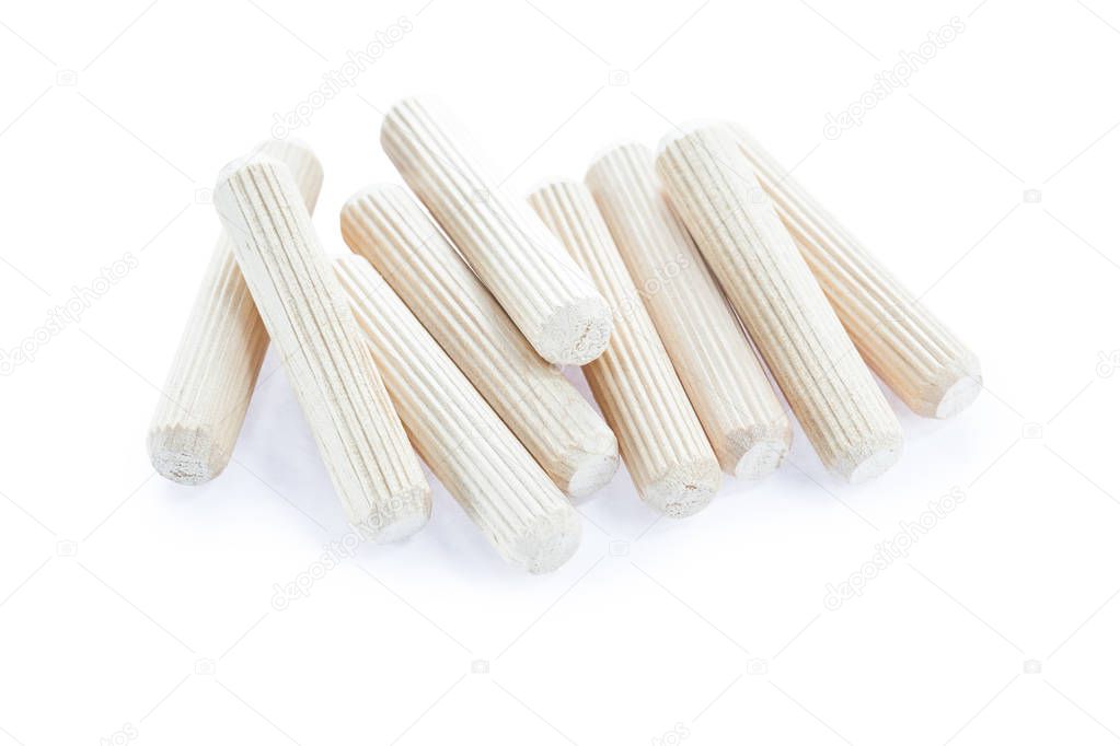 Heap of construction wooden dowels isolated on white
