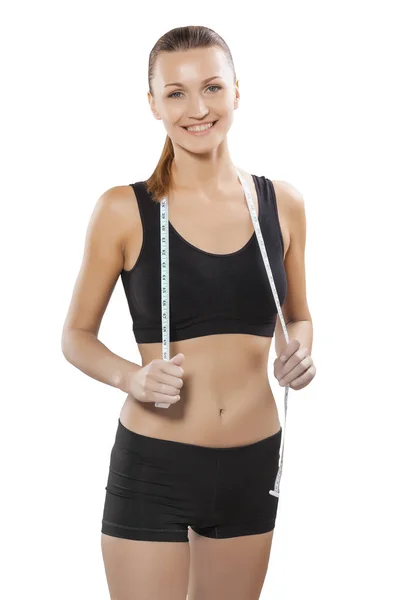 Beautiful sports woman brunette posing with measure tape isolate — Stock Photo, Image