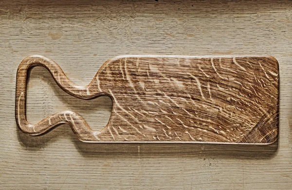 Vintage oak wood serving board on wooden background — Stock Photo, Image