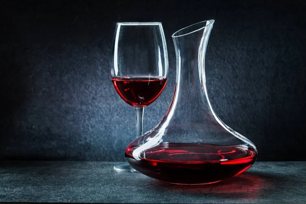 wineglass and decanator with red  wine on dark background