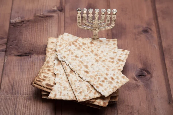 Jewish matza with menorah on table — Stock Photo, Image