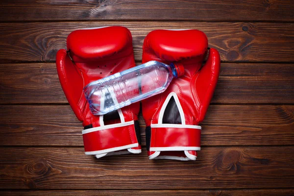 Red Boxing Gloves Bottle Water Wooden Background Stock Image