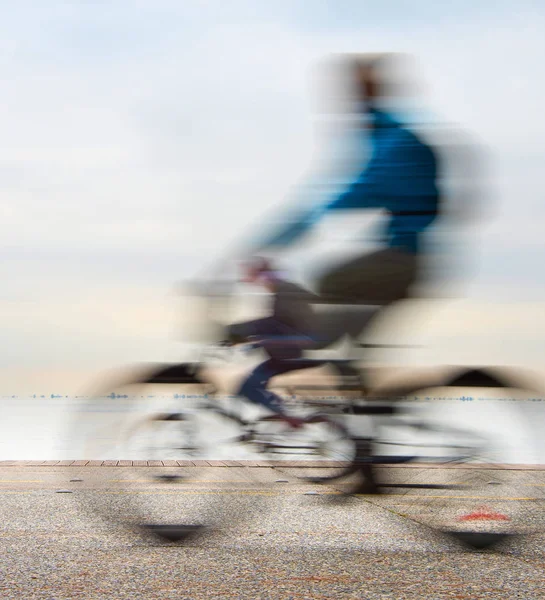 在海的岸边上骑自行车的人 — 图库照片