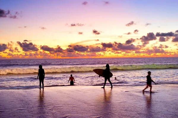 Les gens à la plage au coucher du soleil — Photo