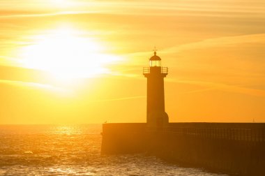 View of lighthouse at sunset. Porto, Portugal clipart