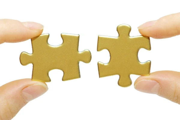 Puzzle pieces in hands — Stock Photo, Image