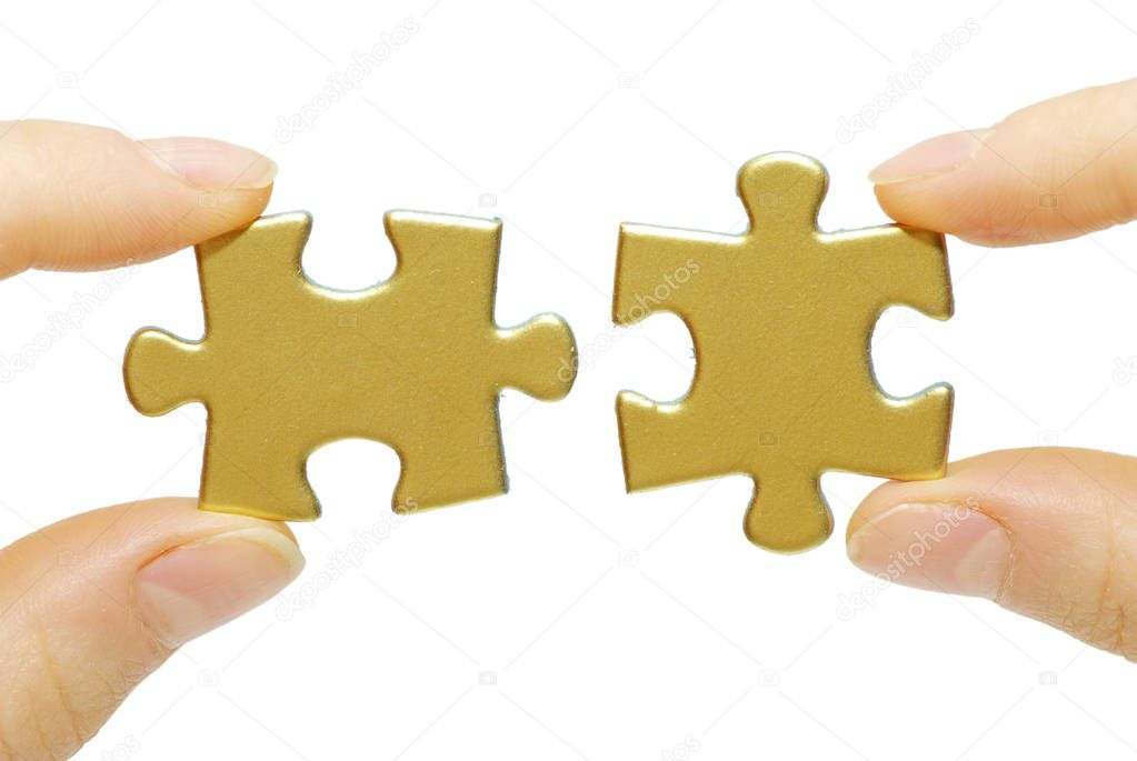  puzzle pieces in hands