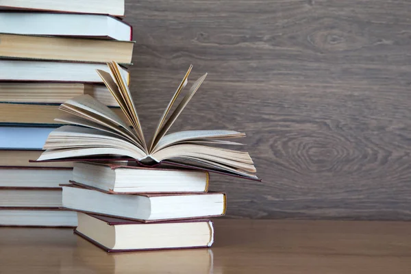 Stacks of books on wooden deck — Stock Photo, Image