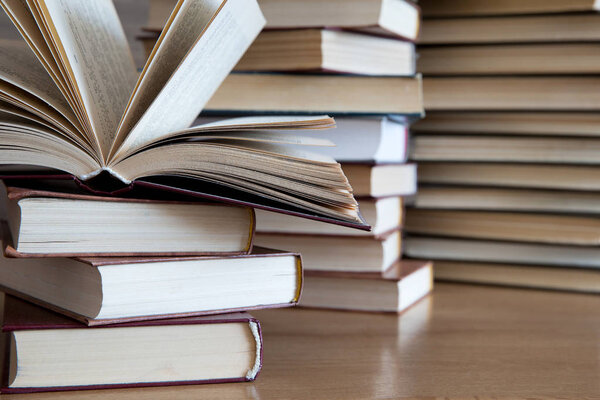 stacks of books on wooden deck