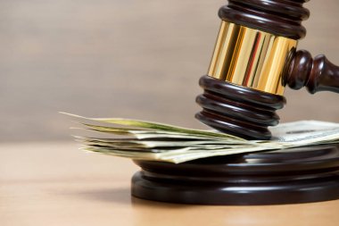 Law gavel on a stack of American money clipart