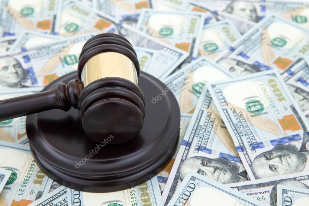 judge gavel and money on brown wooden table concept