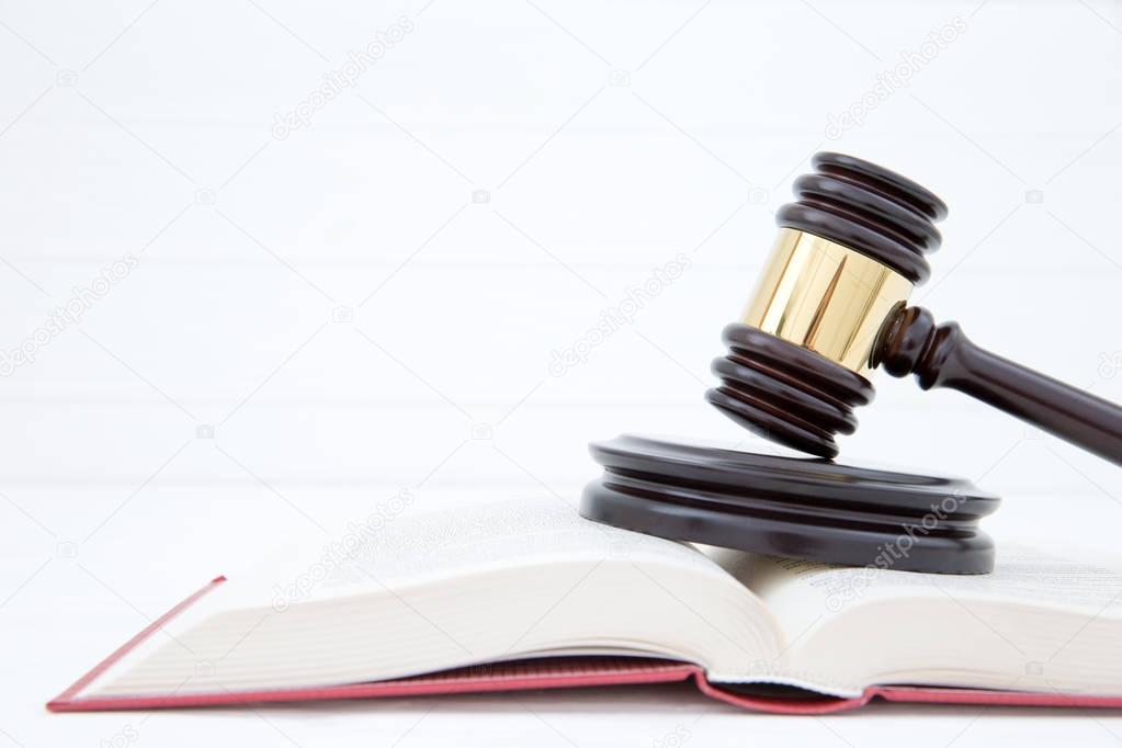 wooden gavel and books on wooden table