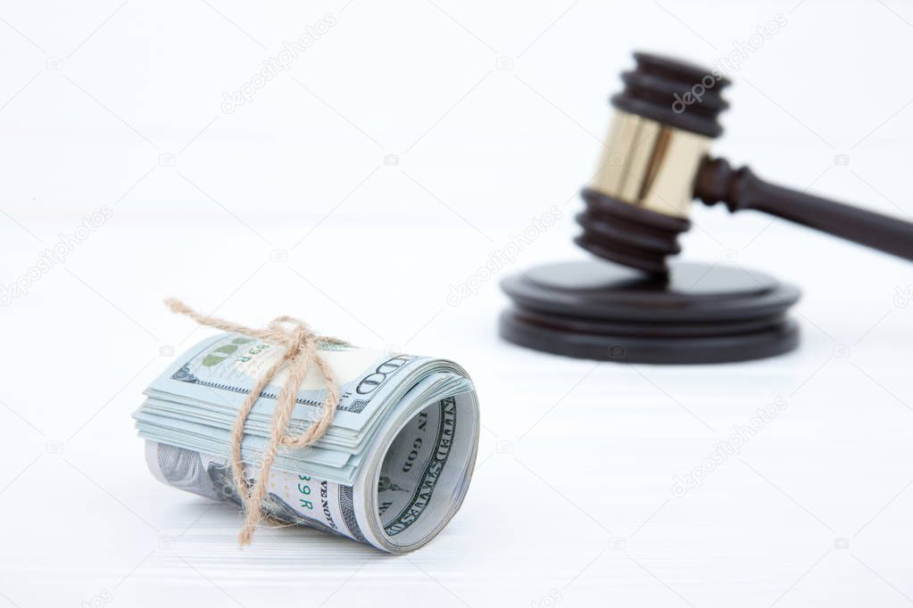 judge gavel and money on brown wooden table concept