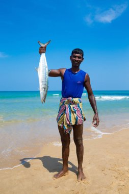 Kosgoda, Sri Lanka, Mach 23: Hint Okyanusu'ndan yakalayan balık shoving yerel balıkçı.