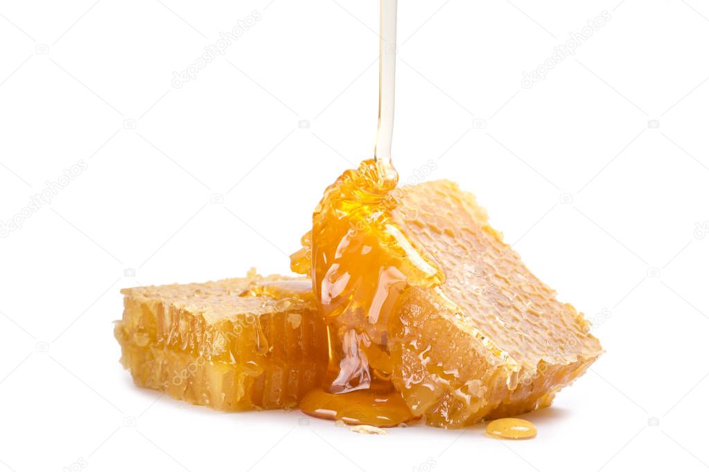 Honeycomb with honey dipper isolated on white background
