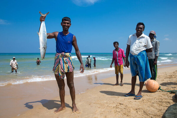 SRI LANKA - Mach 23: Local fishermen pull a fishing net from Indian Ocean on Mach 23, 2017 in Kosgoda, Sri Lanka. Fishing in Sri Lanka is the way they earn their living.