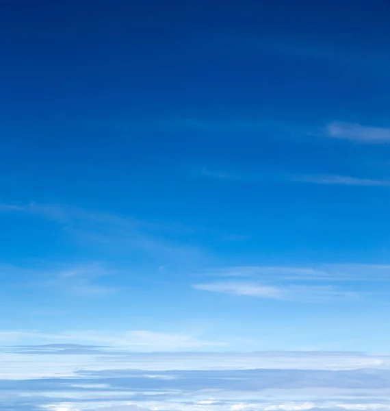 blue sky background with tiny clouds