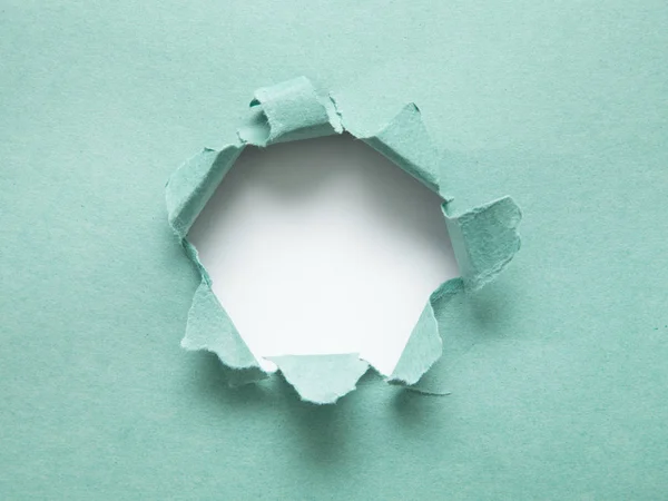 Un agujero en el papel con los lados arrancados. Papel roto. Con espacio — Foto de Stock