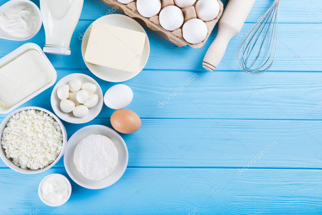 Dairy products on wooden table. Milk, cheese, egg, curd cheese a