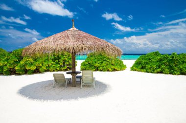 Beyaz kumlu güzel bir sahil. Bulutlu mavi denizler