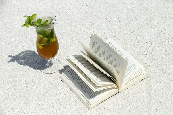 open book and summer drink on white background