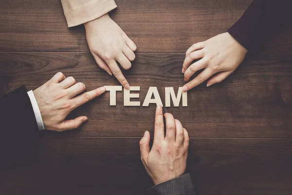 team concept on the brown wooden table background