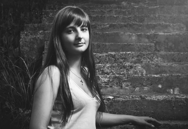 Christian girl sitting on stairs — Stock Photo, Image