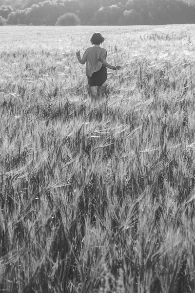 Девушка бежит по зеленому полю утром — стоковое фото