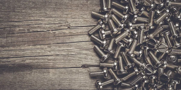 Bolts on the wooden table — Stock Photo, Image